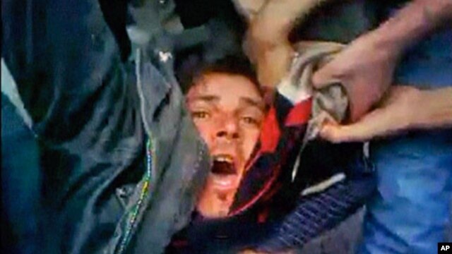 An injured protester is helped by others around him in a location provided as Homs April 22, 2011 in this still image taken from video