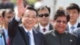 Chinese Premier Li Keqiang waves as he is received by Indian junior minister for external affairs, E. Ahamed, right, after he arrived in New Delhi, India, May 19, 2013. 