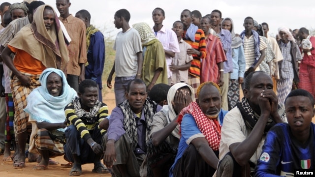 Newly arrived Somali refugees line up to wait for the reception center to open at Ifo settlement at Kenya's Dadaab Refugee Camp, situated northeast of the capital Nairobi near the Somali border, September 1, 2011.  