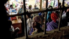 A Congolese woman refugee sits with others at the Nkamira transit center for refugees in western Rwanda Saturday, May 5, 2012. 