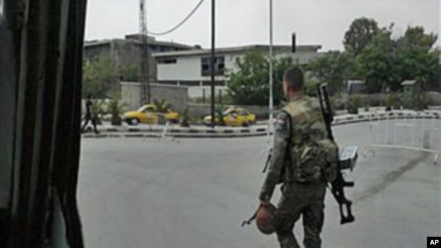 In this image taken on a mobile phone, a Syrian soldier patrols streets in Damascus, Syria, May 8, 2011