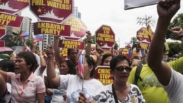Protesters march towards the Chinese consulate during a rally in Manila's financial district of Makati, Philippines, May 11, 2012.
