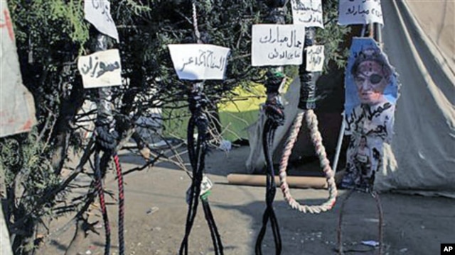 Hanging ropes with names in Arabic for officials from the ousted regime - "Zusan, Jamal Mubarak, Ahmed Ezz, Habib al-Adly and Hosni Mubarak" - are seen at the protest camp in Tahrir square, Cairo, Egypt, July 26, 2011