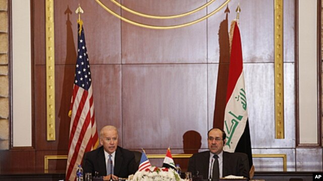 U.S. Vice President Joseph Biden, left, and Iraqi Prime Minister Nouri al-Maliki, right, hold a joint news conference in Baghdad, Iraq, Nov. 30, 2011.