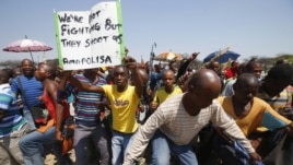 Striking platinum miners march near the Anglo-American Platinum (AMPLATS) mine near Rustenburg in South Africa's North West Province, October 5, 2012. 