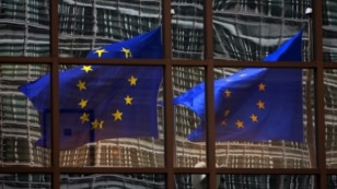 A European flag reflects in a building of the EU headquarters in Brussels. (File)