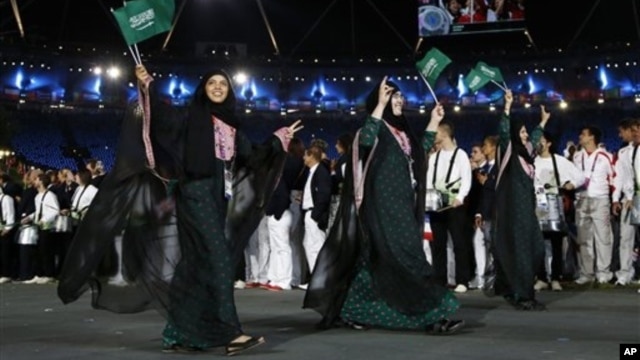 Saudi Arabia's Wojdan Ali Seraj Abdulrahim Shaherkani, center, opening ceremony of the 2012 Summer Olympics, London, July 27, 2012.