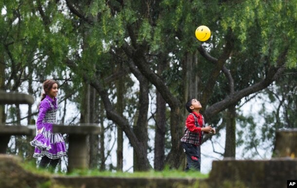 Young Syrian refugees play in the garden of their new temporary residence, the Catholic Marista Brothers of San Jose home, on the outskirts of Montevideo, Uruguay, Oct. 9, 2014.