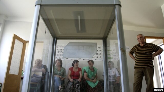 Election commission officials prepare a polling station on the eve of the parliamentary election in Tbilisi, September 30, 2012.