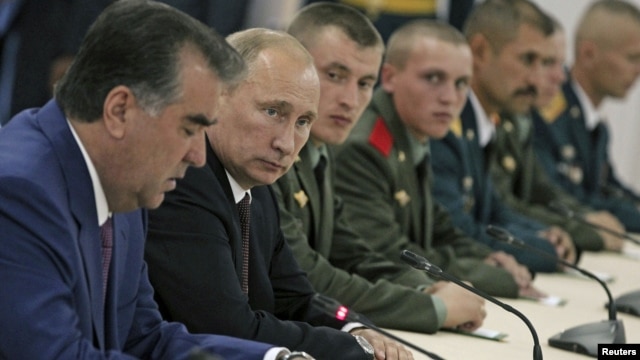 Russia's President Vladimir Putin (2nd L) and his Tajik counterpart Imomali Rakhmon (L) meet with servicemen as they visit a Russian military base in Dushanbe, October 5, 2012. 