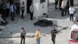 Security and forensic officials and medics investigate around the remains of a car after an explosion outside a police station in Gaziantep, Turkey, May 1, 2016.  