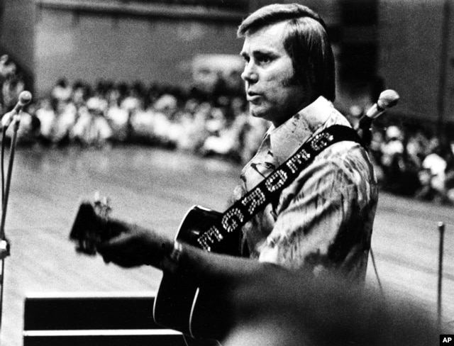 FILE - In this undated photo, Country singer George Jones is shown performing with his guitar.
