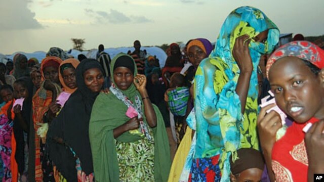Women and Children holding their pink tickets queue for the evening meal at the Dollo Ado transit center in Ethiopia, October 26, 2011.