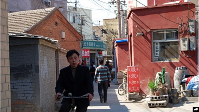 Man rides through the heart of Caochangdi Village