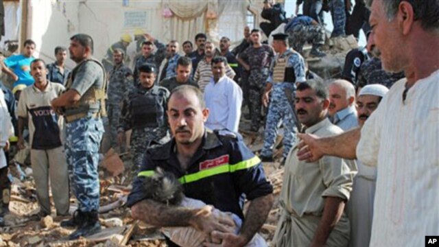 An Iraqi emergency worker carries the lifeless body of 6-month-old Shahad Mohammed from the bombed out ruins of his home in Tikrit, 80 miles (130 kilometers) north of Baghdad, 19 Oct 2010