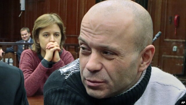 Politkovskaya's daughter Vera, background, looks at former police officer Dmitry Pavlyuchenko, right, prior to the judge's verdict, at the Moscow City Court, Russia, December 14, 2012