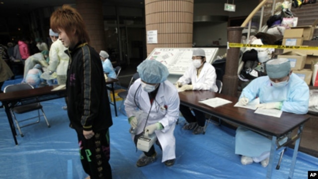 Medical staff screen people who are concerned over radiation exposure in Niigata, northern Japan March 16, 2011.