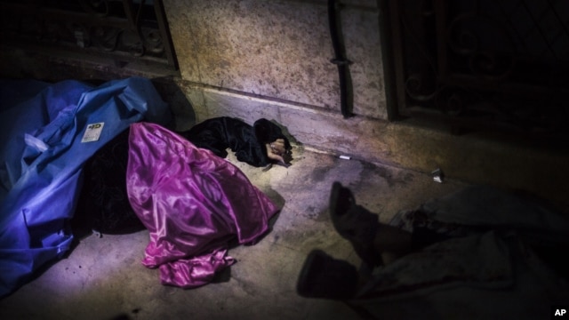 The body of a Syrian woman is seen near Izaz's Hospital after being shot by a sniper in the countryside around Izaz, near the Turkish border with Syria, October 1, 2012.