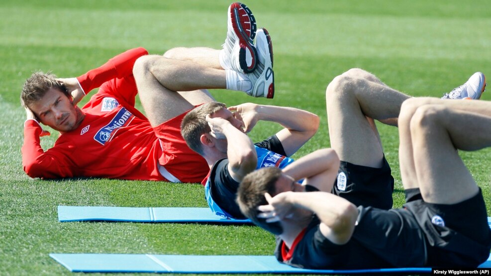 England soccer player David Beckham, left, performs core stability exercise during a training session at Royal Bafokeng Sports Complex where the England soccer team are based, near Rustenburg, South Africa, Friday June 4, 2010.