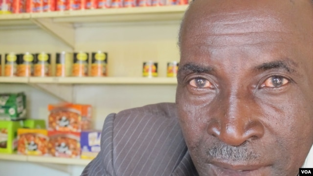 John Stheole has owned his spaza shop for more than a ten years in Dube Village, Soweto, South Africa. (Photo Gillian Parker for VOA)