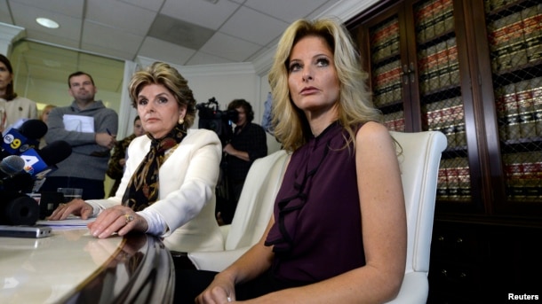Summer Zervos, a former contestant on the TV show "The Apprentice," reacts next to lawyer Gloria Allred, left, while speaking about allegations of sexual misconduct against Donald Trump during a news conference in Los Angeles, Oct. 14, 2016.