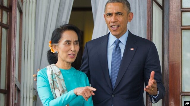 President Barack Obama, right, walks out with Myanmar's opposition leader Aung San Suu Kyi at her home before the start of their joint news conference in Yangon, Myanmar. Friday, Nov. 14, 2014. (AP Photo/Pablo Martinez Monsivais)