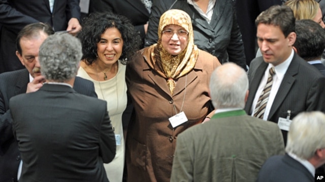 Electoral delegate for the Christian Democratic Party (CDU) Mevluede Genc, center, a German of Turkish origin, stands with other delegates in the Reichstag in Berlin,  March 18, 2012.