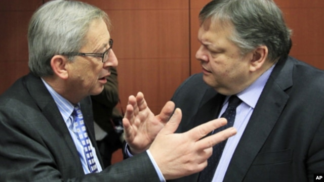 Luxembourg's Prime Minister and Eurogroup chairman, Jean-Claude Juncker (L) talks with Greece's Finance Minister Evangelos Venizelos at the start of a Eurogroup meeting at the European Union council headquarters in Brussels, February 9, 2012.