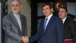 Iranian Foreign Minister Ali Akbar Salehi (L) and his Turkish counterpart Ahmet Davutoglu are seen before a meeting in Ankara, Turkey, August 7, 2012.
