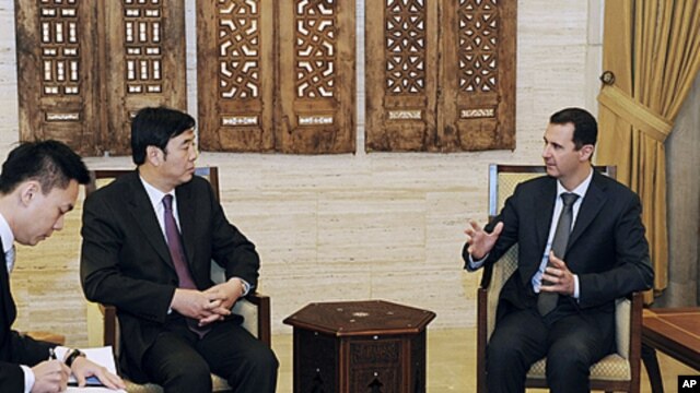 Syria's President Bashar al-Assad (R) meets Chinese Vice Foreign Minister Zhai Jun in Damascus, February 18, 2012.