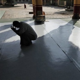 A Burmese man prays at a temple in Bago, northeast of Rangoon, on Election Day.
