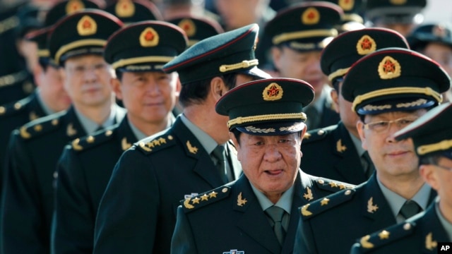 FILE - Chinese military officers arrive outside the Great Hall of the People in Beijing.