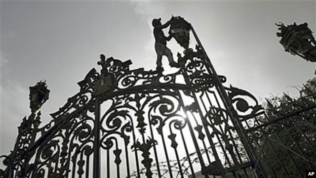 A worker makes repairs to a fence outside the People's Assembly as final preparations are made for the opening session January 23 of the first post-Hosni Mubarak parliament session, several days ahead of the one-year anniversary of Egypt's revolution, in 