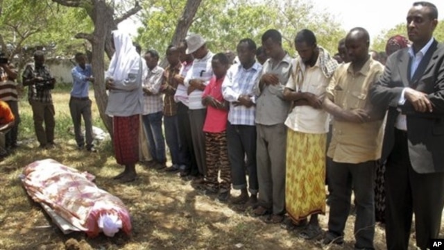 Mourners attend the funeral for Abdisatar Dahir Sabriye, a journalist with state-run television who fell victim to a recent suicide bombing, Mogadishu, Sept. 21, 2012.