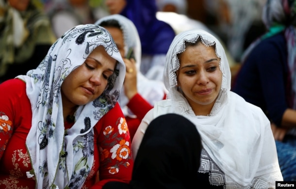 Women mourn as they wait in front of a hospital morgue in the Turkish city of Gaziantep, after a suspected bomber targeted a wedding celebration in the city, Turkey, Aug. 21, 2016.