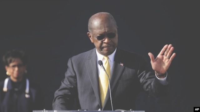 Republican presidential candidate Herman Cain announces he is suspending his campaign as his wife Gloria, left, looks on,  Atlanta, Georgia, December, 3, 2011.