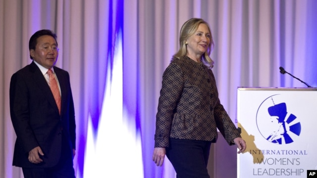 U.S. Secretary of State Hillary Rodham Clinton, right, and Mongolian President Elbegdorj Tsakhia arrive at the International Women's Leadership Forum held inside Parliament in Ulaanbaatar, Mongolia, July 9, 2012. 