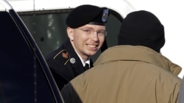 Army Pfc. Bradley Manning, center, steps out of a security vehicle as he is escorted into a courthouse in Fort Meade, Md.,  Nov. 28, 2012.