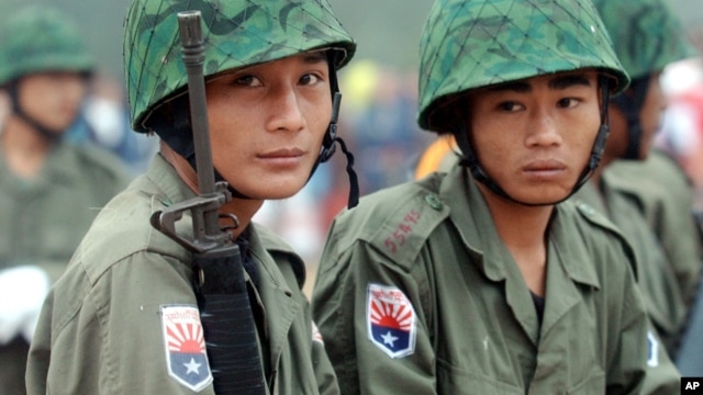 Two young Karen soldiers guard his jungle camp of Mi Aye Bo in Burma's Karen state near the Thai border during a Karen New Year celebration, December 23, 2003. 