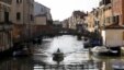 A bridge that once separated the Venice ghetto (L) from Catholic Venice (R) is seen as a boat passes northern Italy, March 22, 2016. 