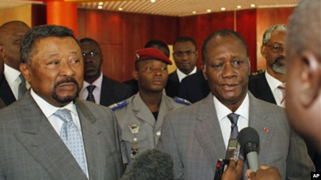 Ivory Coast's internationally-recognized President, Alassane Ouattara, right, addresses journalists following a meeting with African Union commission chairman Jean Ping, left, at the Golf Hotel in Abidjan, Ivory Coast, March 5, 2011