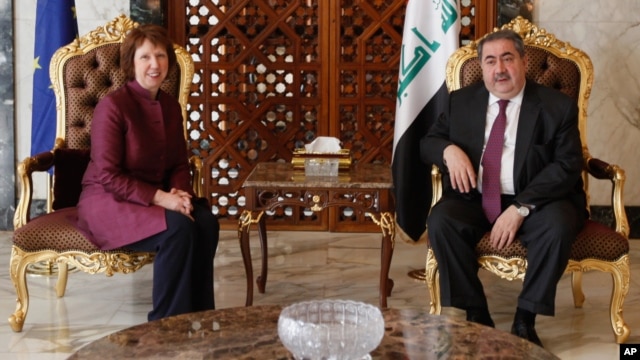 Iraq's Foreign Minister Hoshyar Zebari, right, meets with EU foreign policy chief Catherine Ashton upon her arrival at Baghdad International Airport in Iraq, May 23, 2012.