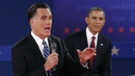 U.S. Republican presidential nominee Mitt Romney (L) answers a question as U.S. President Barack Obama looks on during the second U.S. presidential campaign debate in Hempstead, New York, October 16, 2012. 