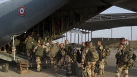 This picture released by the French Army Communications Audiovisual office shows French soldiers boarding for Bamako at N'Djamena's airport, in Chad, Jan. 11, 2013.