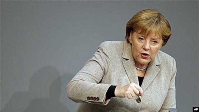 German Chancellor Angela Merkel gestures during her speech at the German federal parliament, the Bundestag, in Berlin, Germany, December 14, 2011.