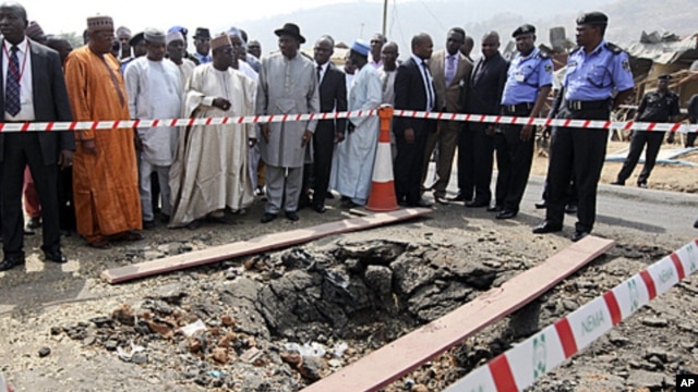 Nigerian President Goodluck Jonathan (C, with black hat) visits St. Theresa's Catholic church, the scene of a Christmas day bomb attack, just outside the capital Abuja, (file photo)
