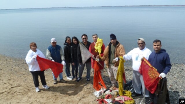 The cleanup volunteers accumulate a pile of prayer flags, saris and other trash left over from sacred Hindu ceremonies.