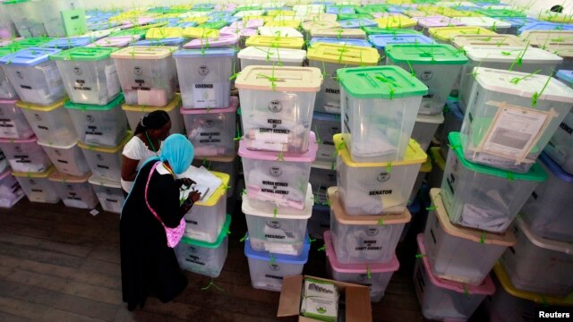 Polling clerks record information on a pile of ballot boxes containing cast ballot papers at the Chandaria tallying center in Kenya's coastal city of Mombasa, March 6, 2013. 