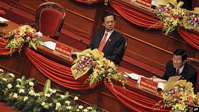 Politburo member Truong Tan Sang, right, reads a document while Vietnamese Prime Minister Nguyen Tan Dung looks on at the opening ceremony of the 11th National Congress of the Vietnamese Communist Party in Hanoi, Vietnam on January 12, 2011