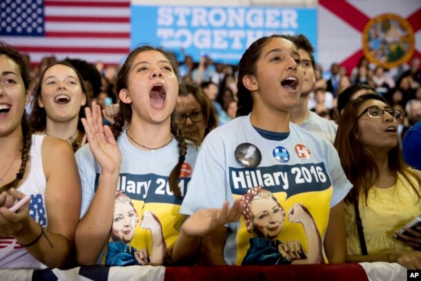 Members of the audience cheer as Democratic presidential candidate Hillary Clinton speaks at a rally at Palm Beach State College in Lake Worth, Florida, Oct. 26, 2016.